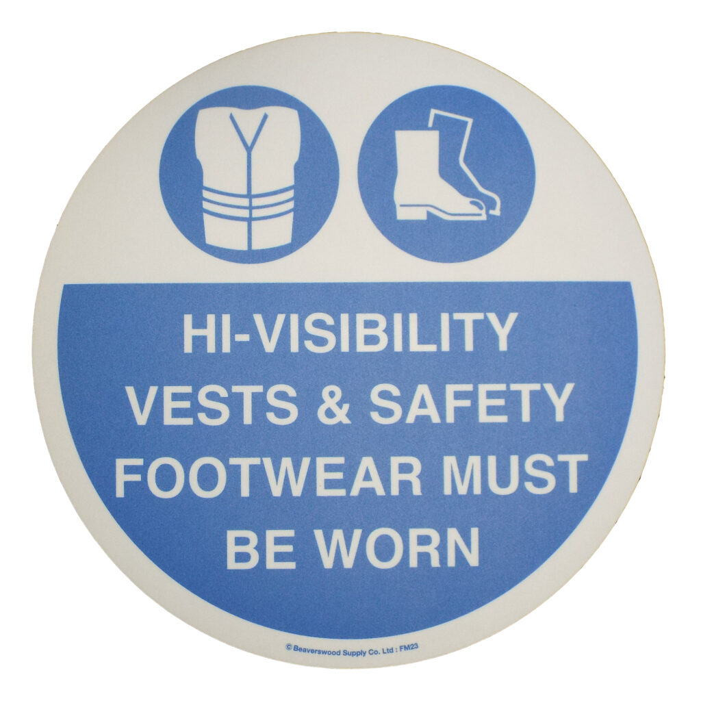 Large circular floor sign with symbols and text saying hi-visibility vests and footwear must be worn